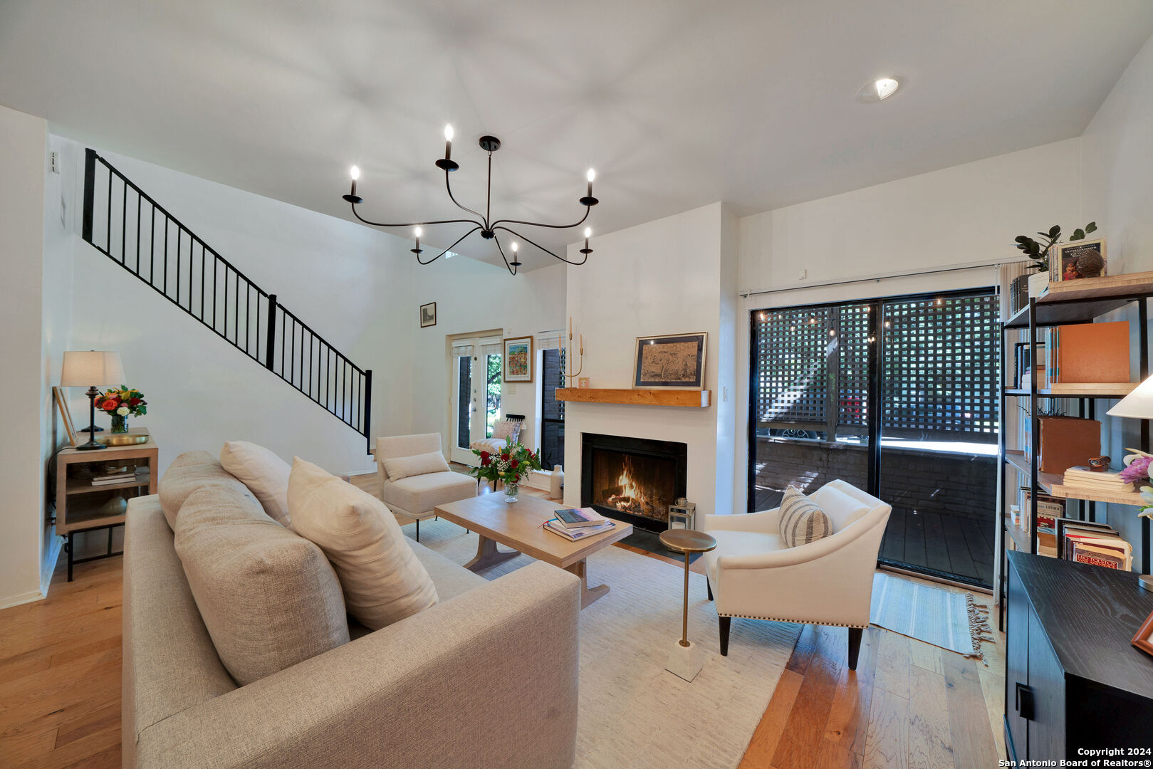 a living room with furniture a fireplace and a flat screen tv