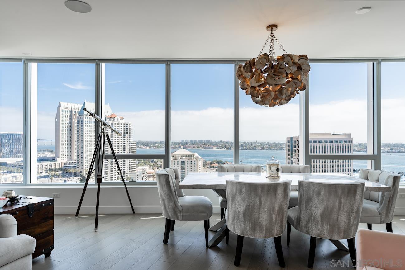 a dining room with furniture window and wooden floor