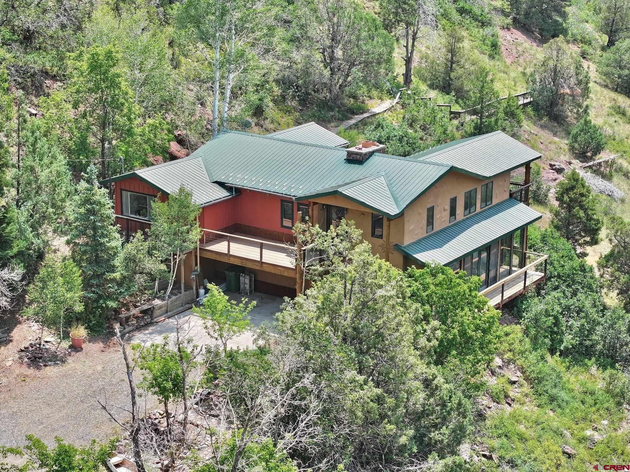 an aerial view of a house with a yard basket ball court and outdoor seating