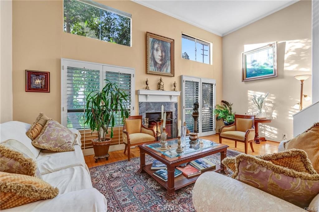 a living room with furniture large window and a fireplace