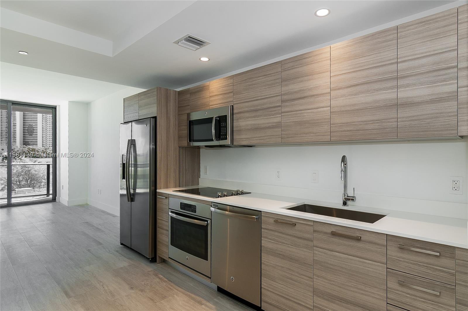 a kitchen with a sink stainless steel appliances and cabinets