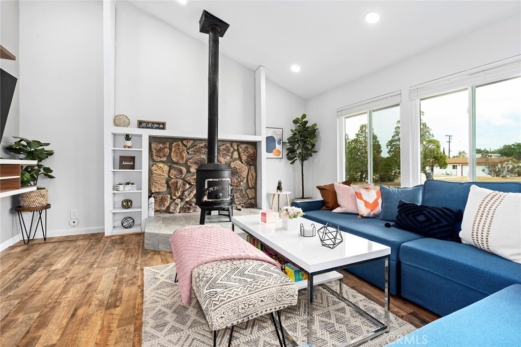 a living room with furniture and a floor to ceiling window