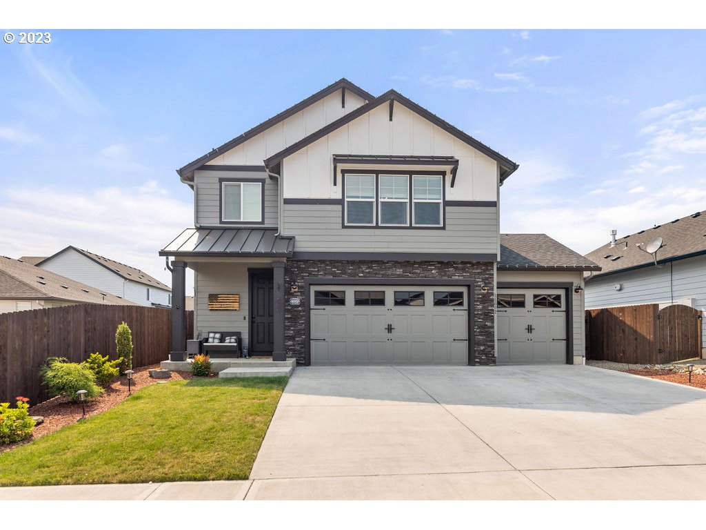 a front view of a house with a yard and garage