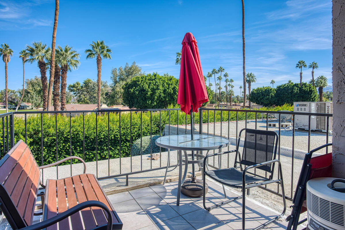 a view of a chair and tables in the patio