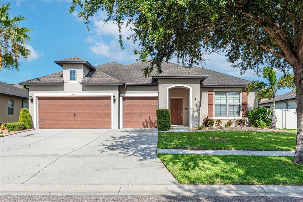 a front view of a house with a yard and garage