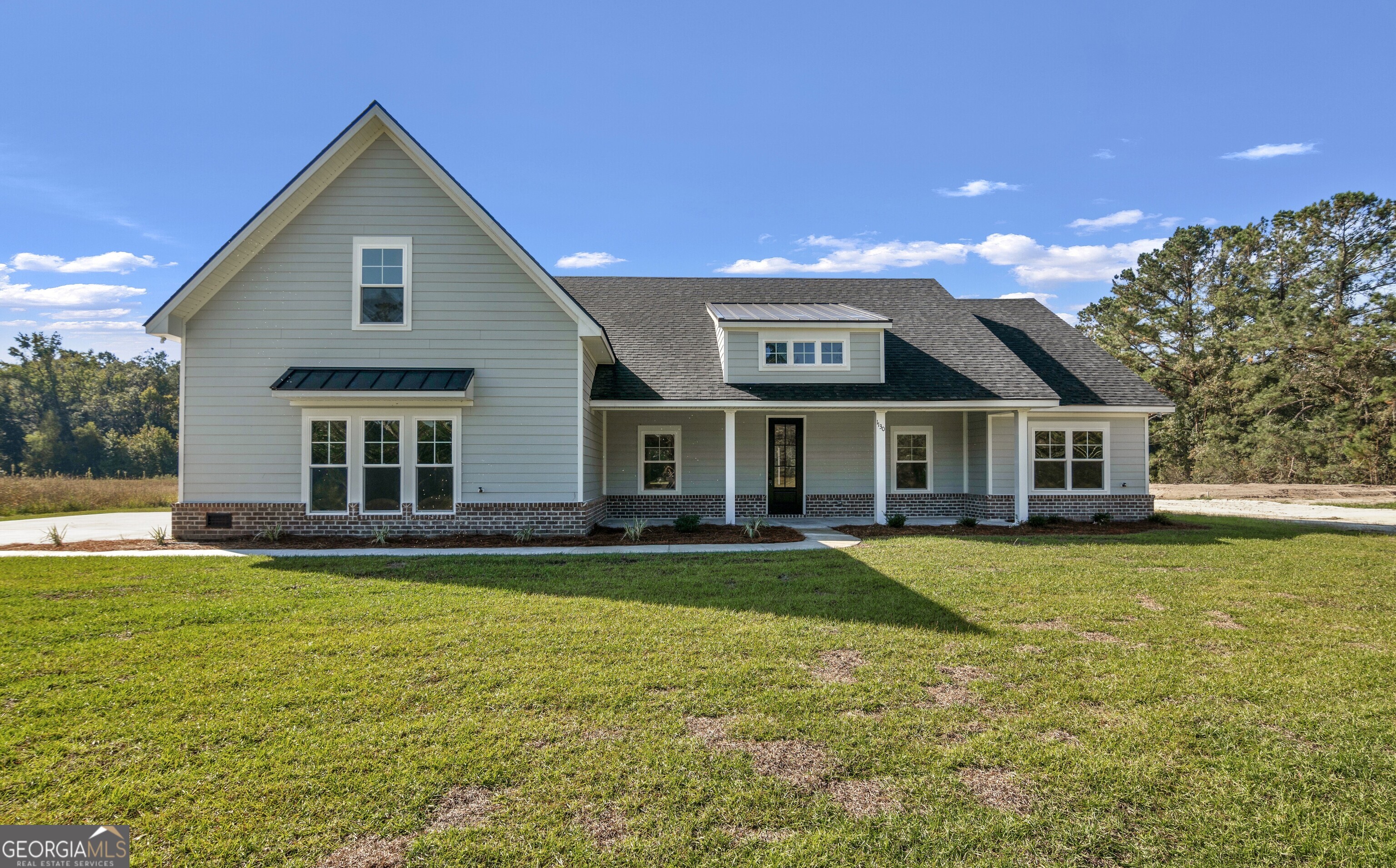 a front view of house with yard and swimming pool