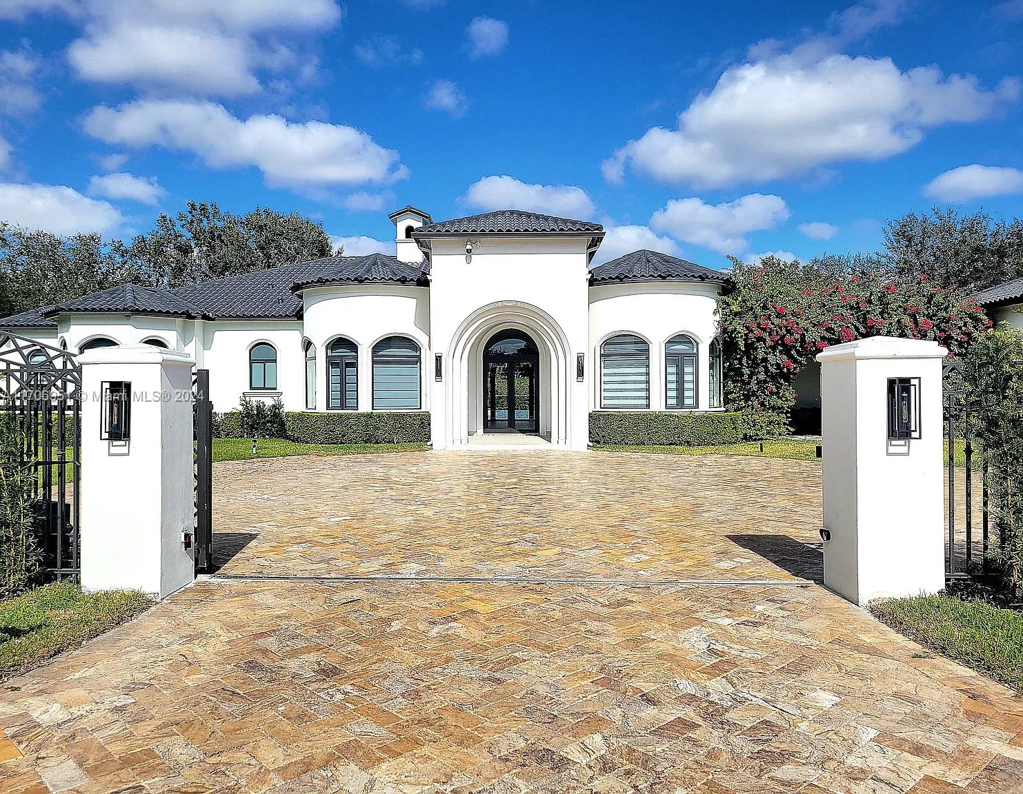 a view of a white house with a yard