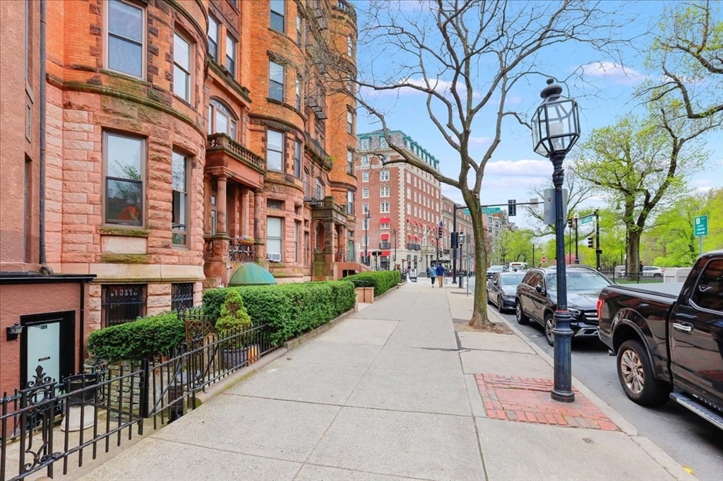 a view of a brick building next to a road