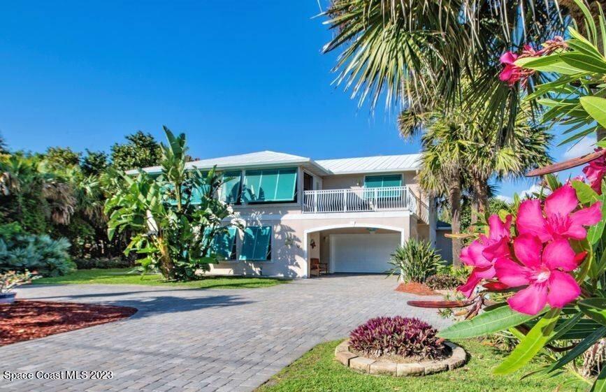 a front view of a house with a yard and fountain