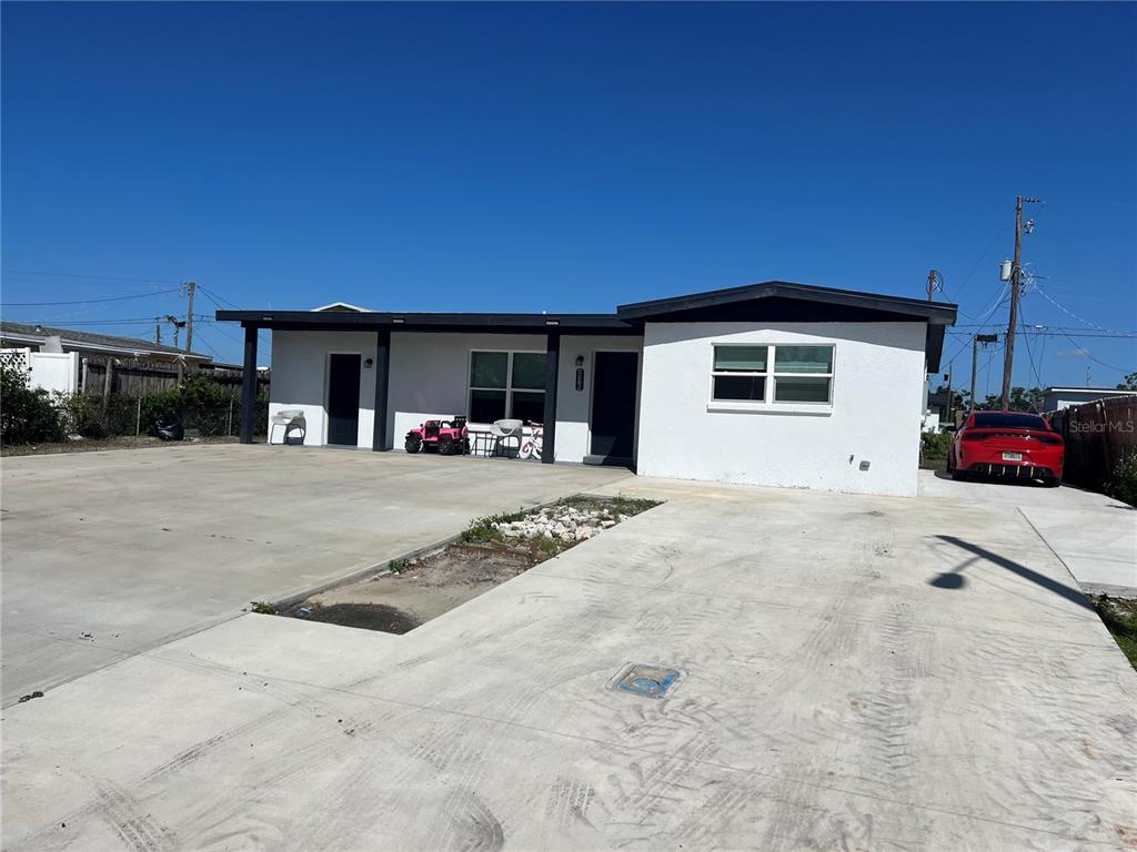 a view of a house with cars in front of it