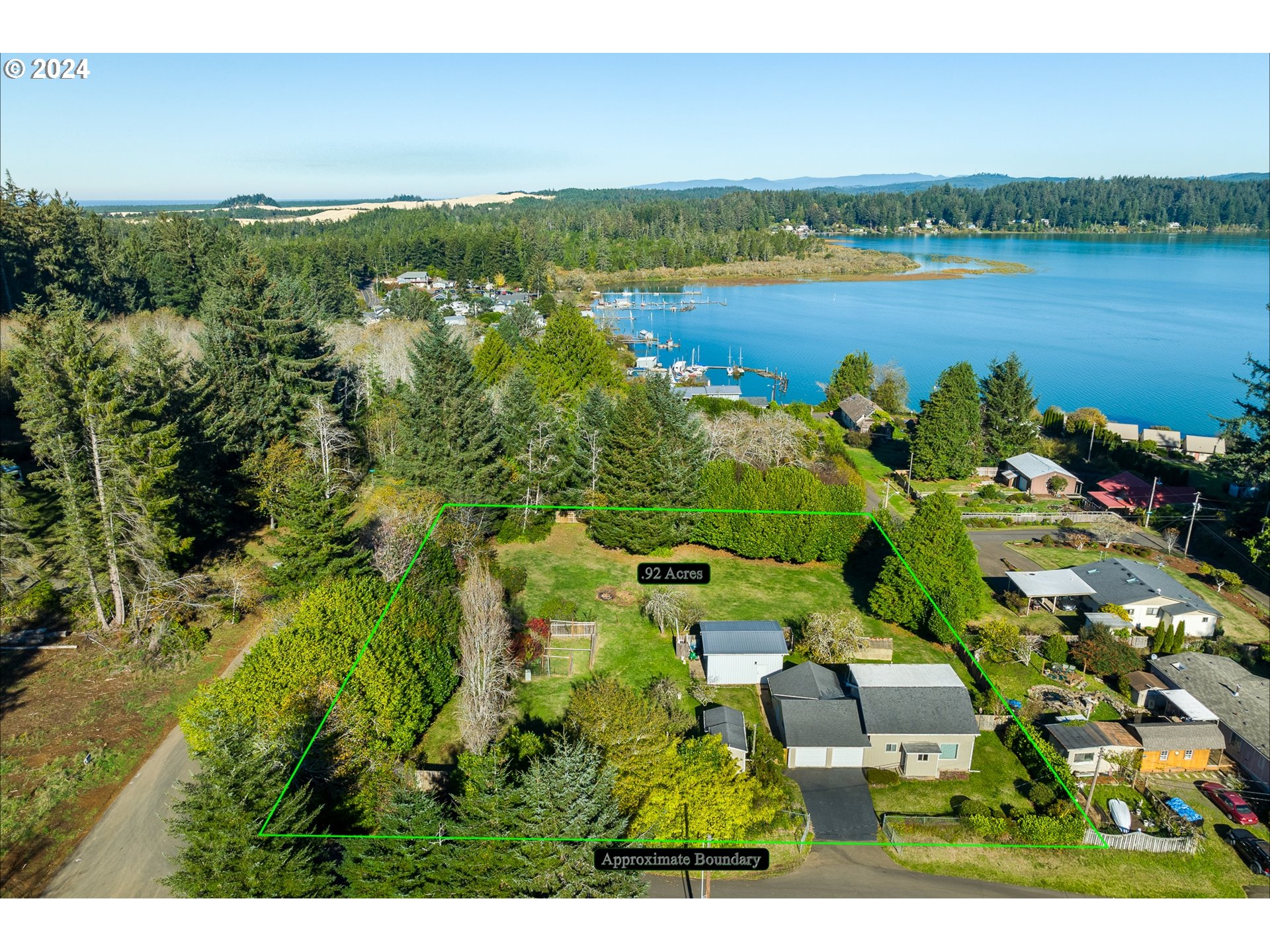 an aerial view of residential houses with outdoor space and river