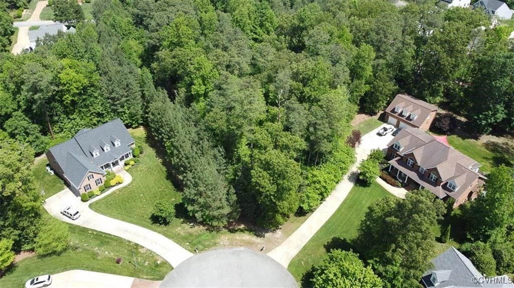 an aerial view of a house with a garden and trees