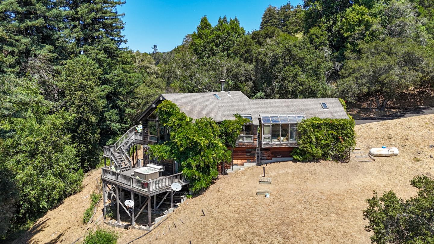 an aerial view of a house having patio with a table and chairs