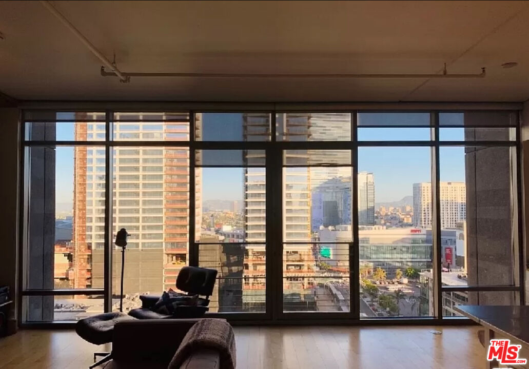 a living room with furniture and floor to ceiling window