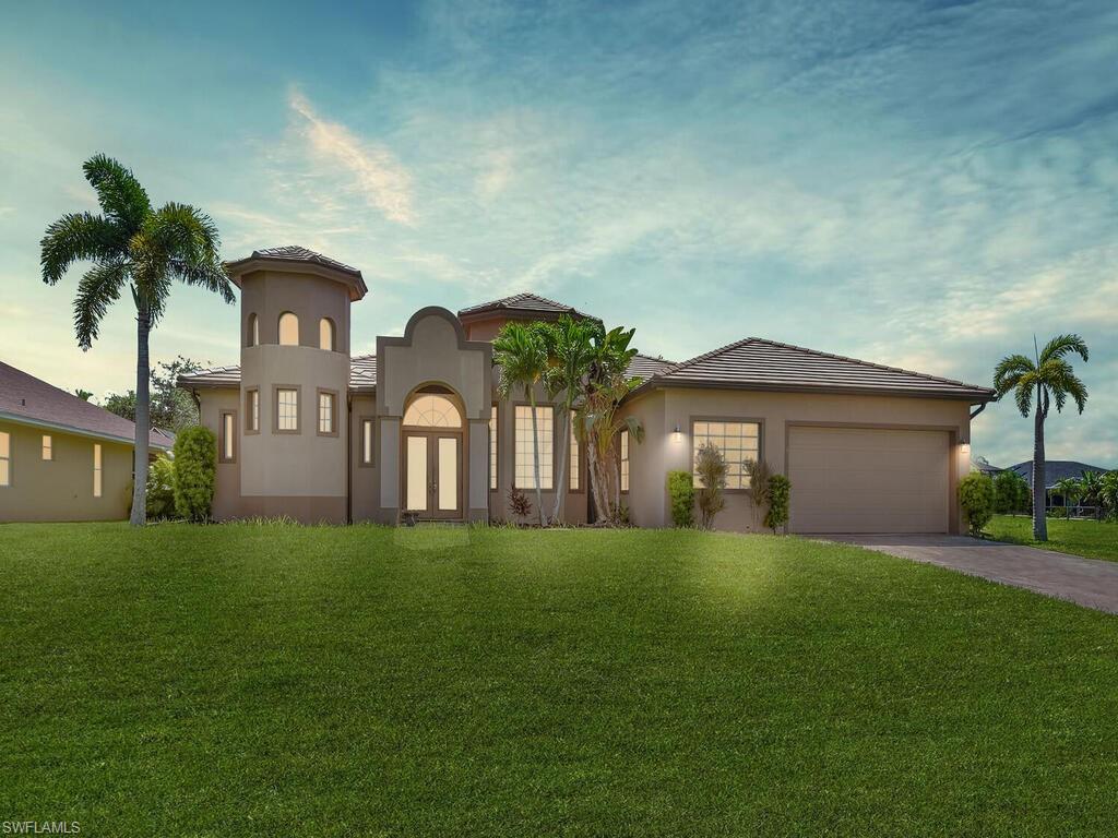 a front view of a house with a yard and garage