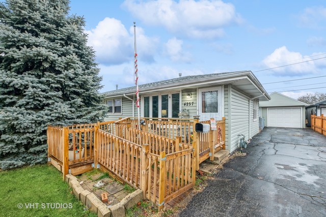 a view of a house with wooden fence