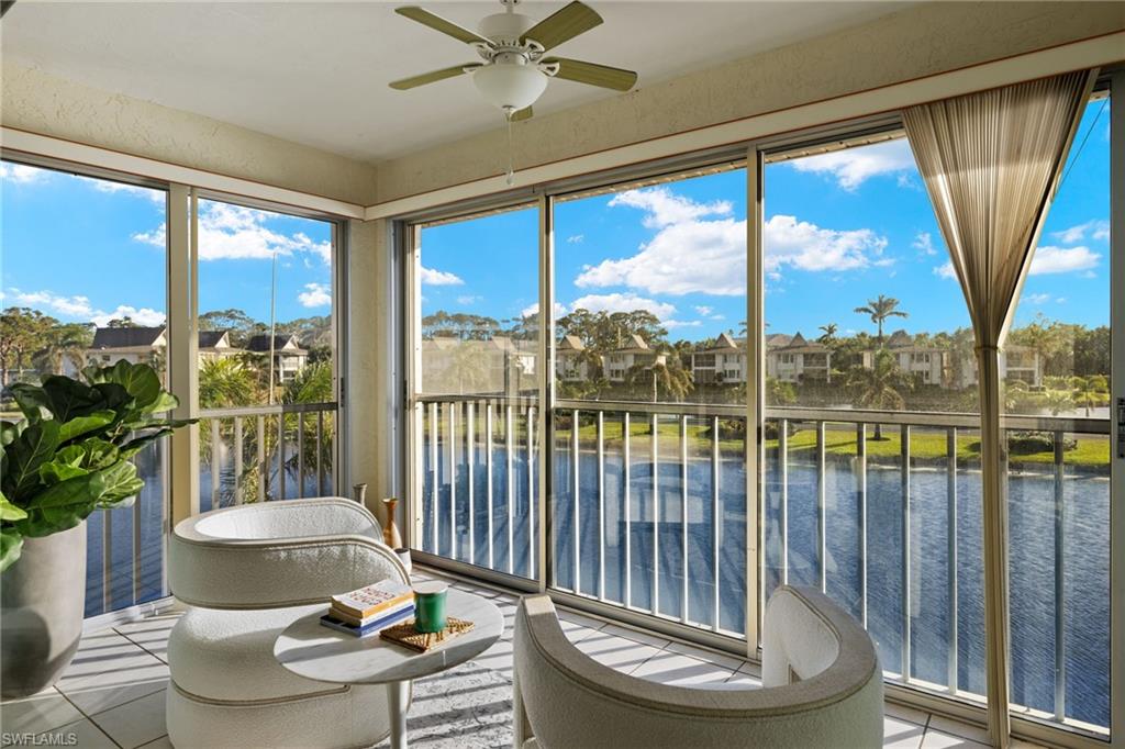 Sunroom with ceiling fan, a water view, and a wealth of natural light