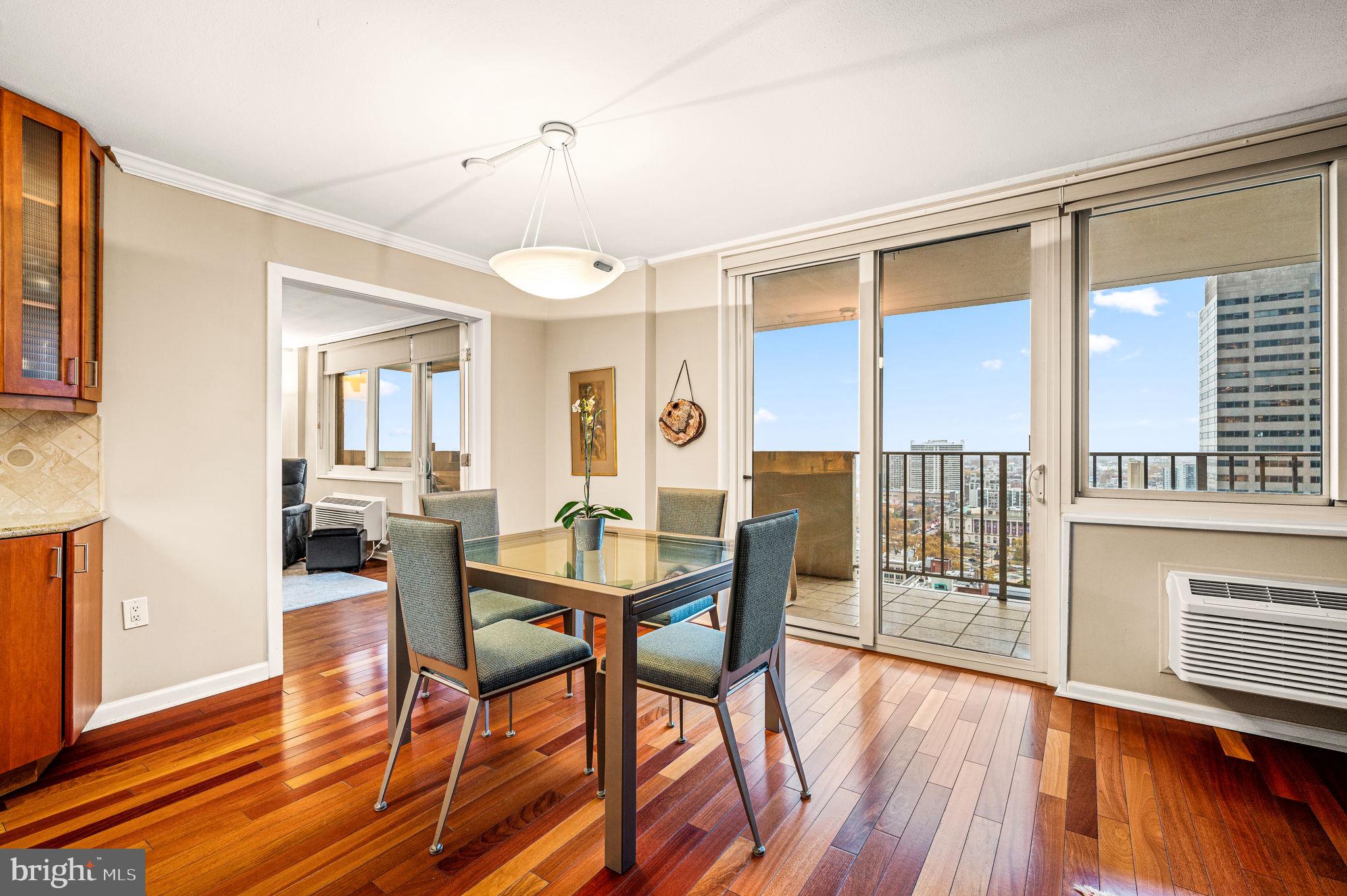 a view of a dining room with furniture window and wooden floor