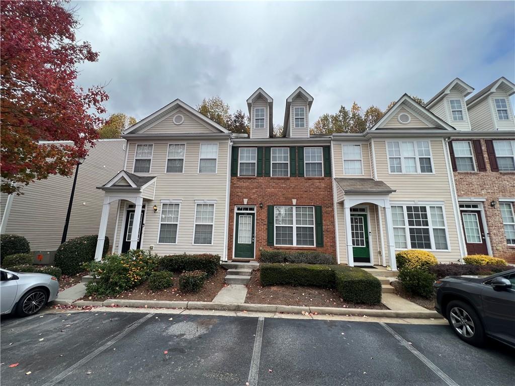 a front view of a residential apartment building with a yard