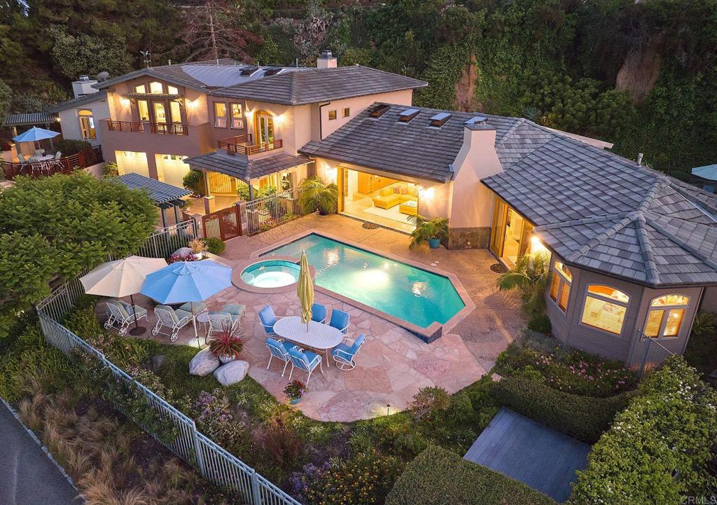 an aerial view of a house with swimming pool patio and outdoor seating