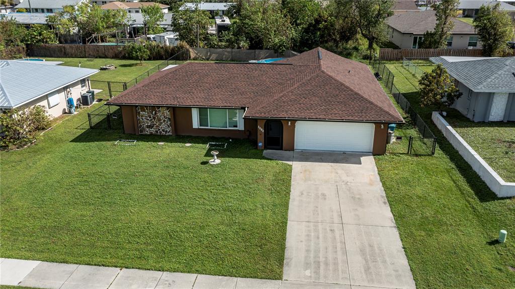 a aerial view of a house with a yard