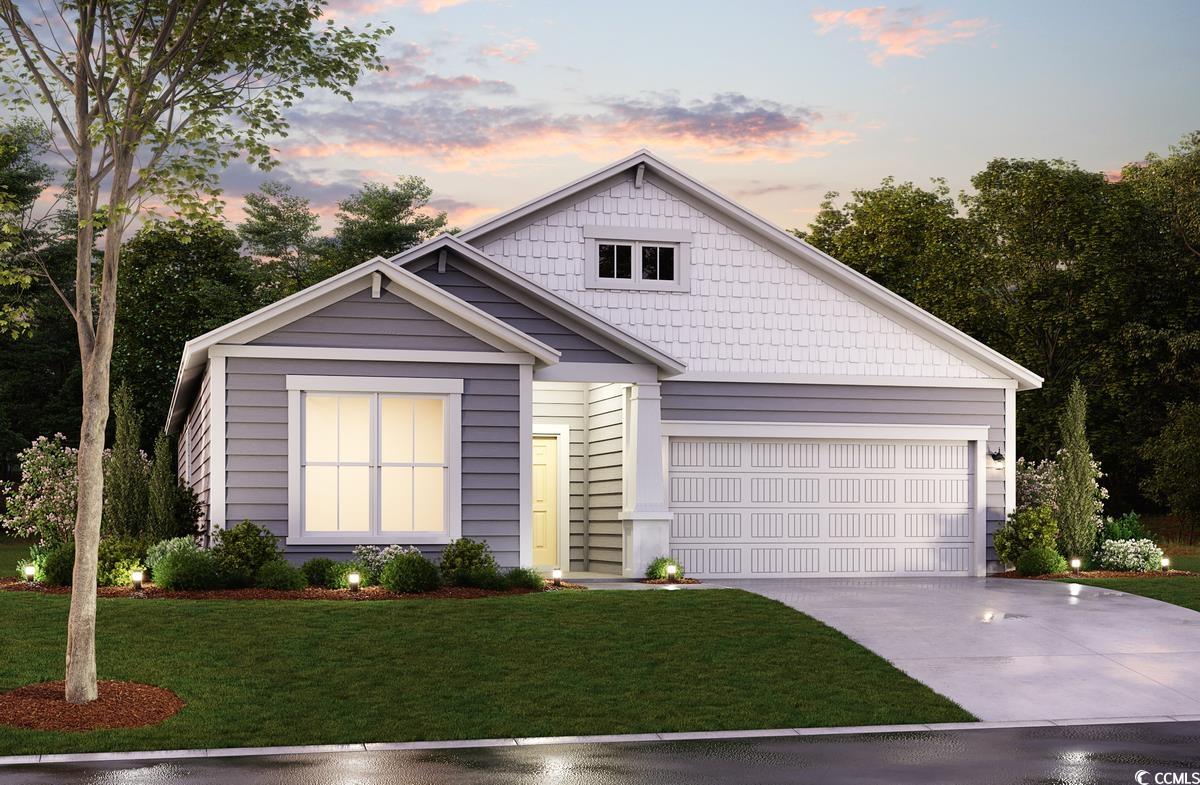 View of front of house featuring a garage and a ya