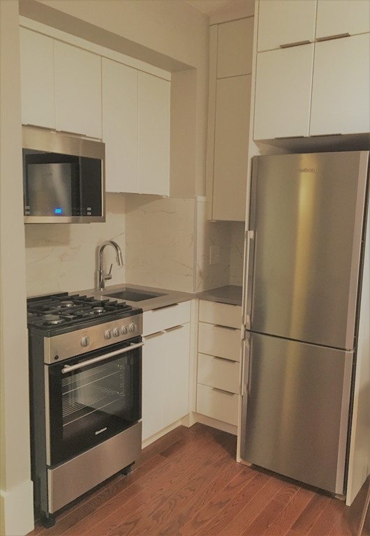 a kitchen with a stove microwave and refrigerator