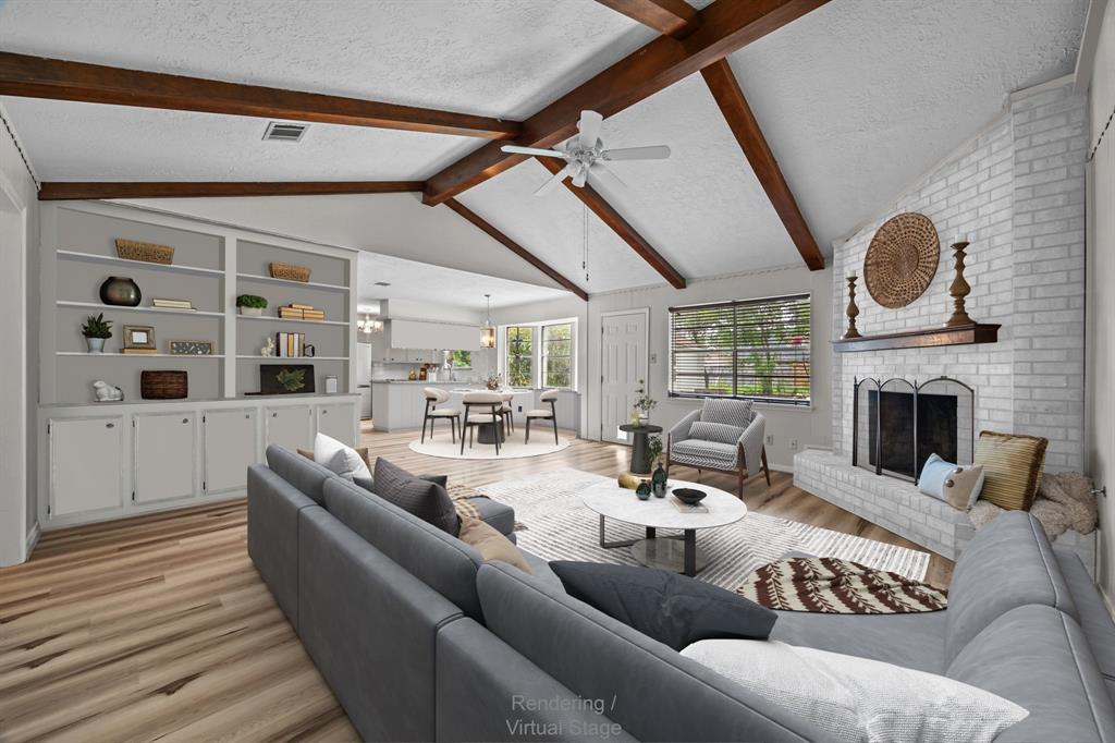 a living room with furniture fireplace and a table