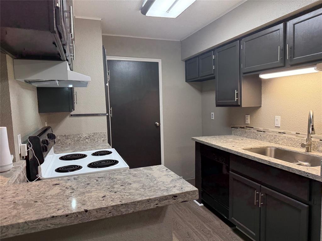 a kitchen with a sink stove and refrigerator