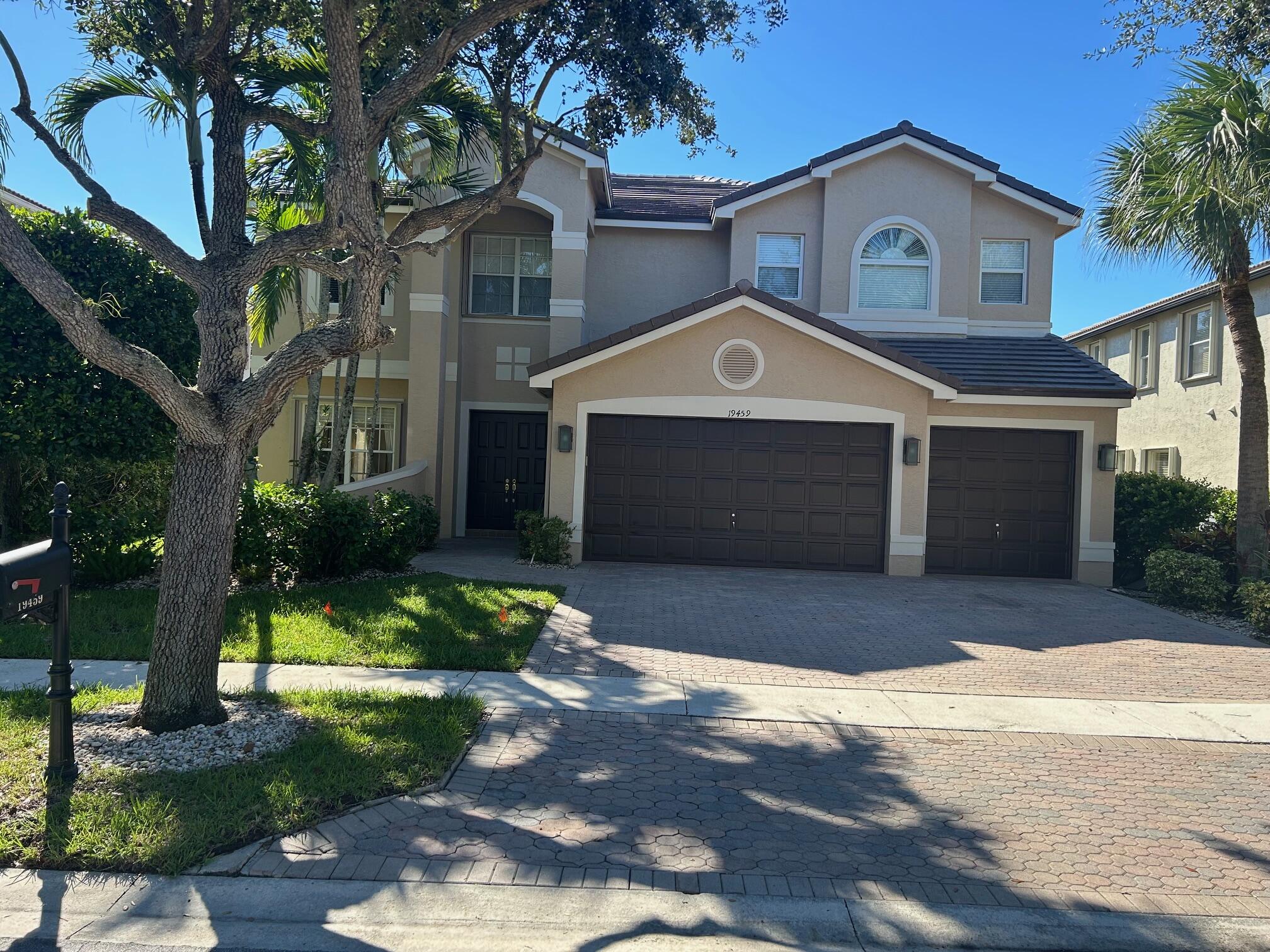 a front view of a house with a yard and garage