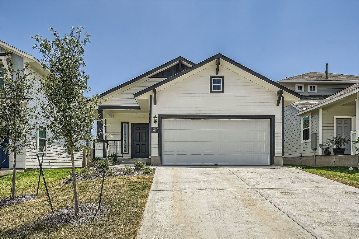 a view of a house with a yard and garage