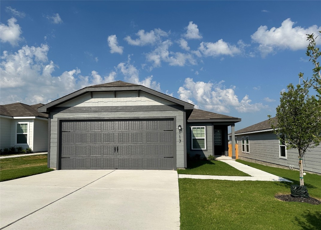 a front view of a house with a yard and garage