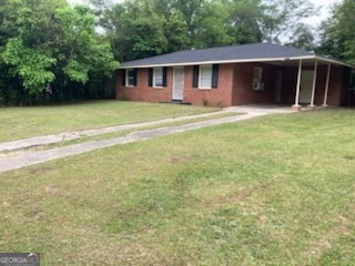 a front view of a house with yard and trees