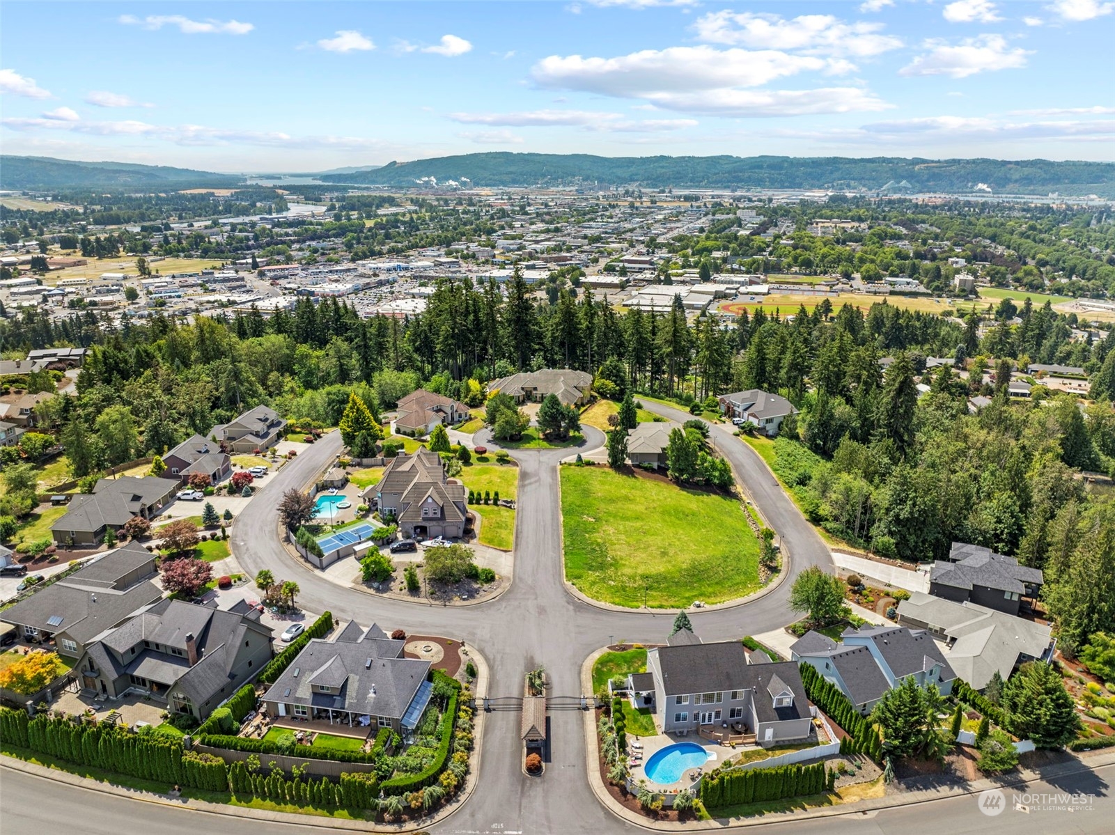 an aerial view of a houses with a swimming pool