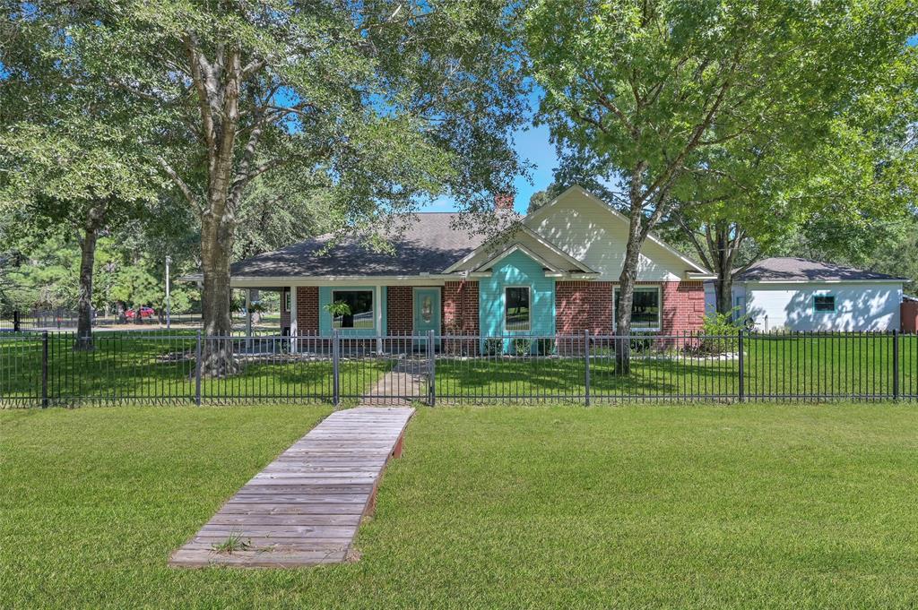 a front view of house with yard and green space