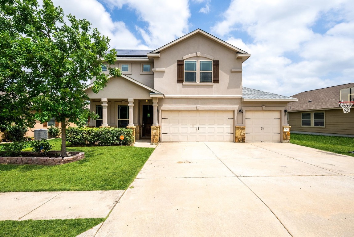 a front view of a house with a yard and garage