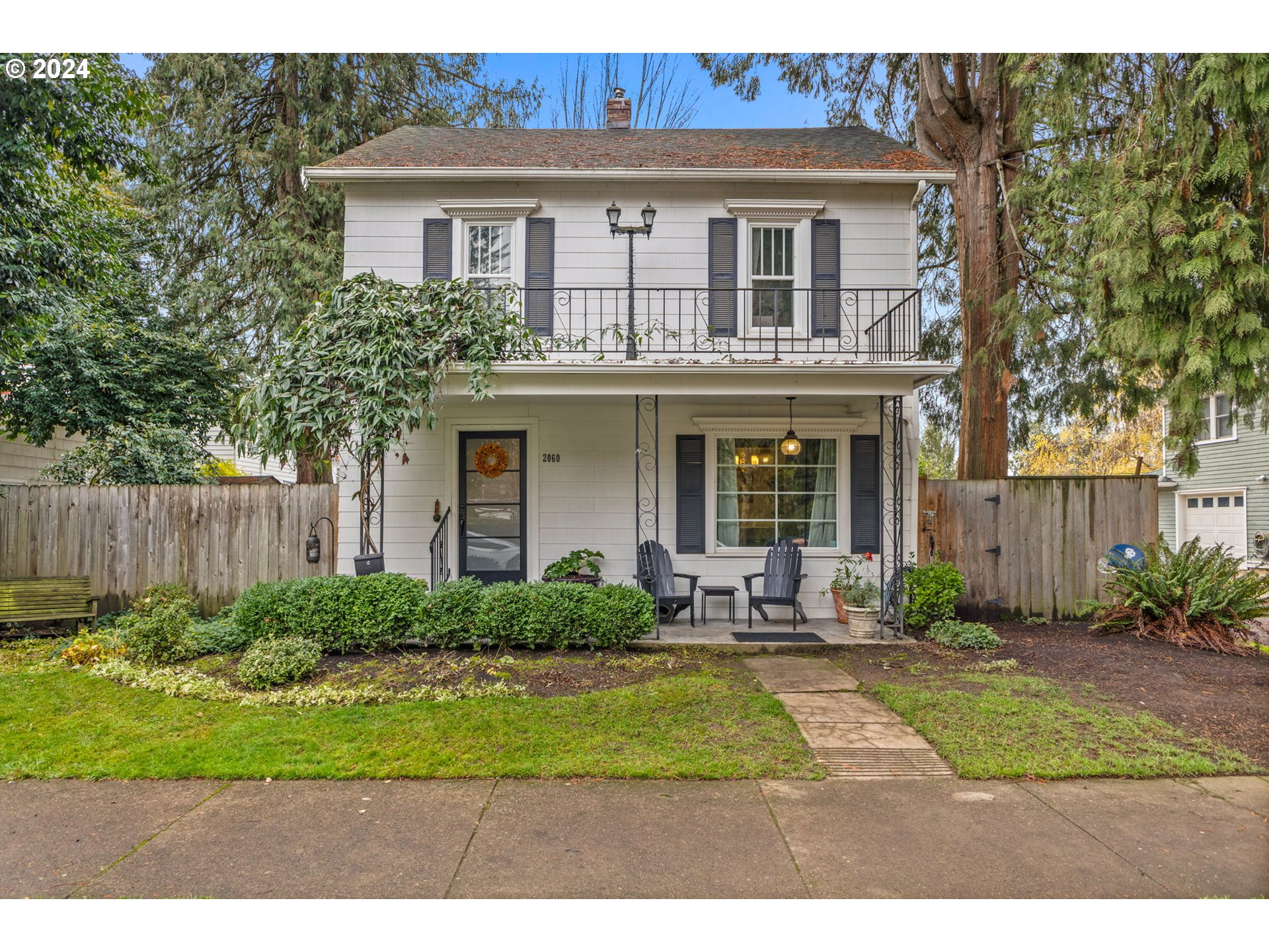 a front view of a house with garden and porch