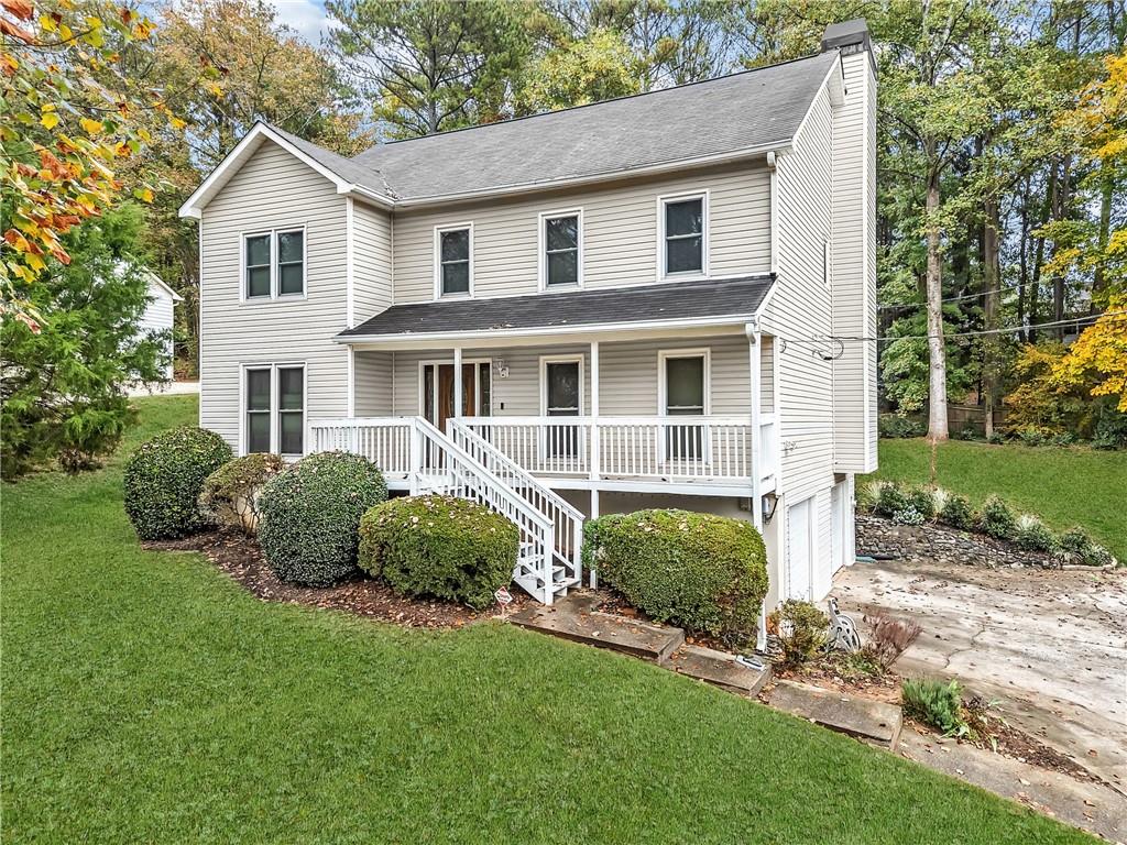 a front view of a house with a garden