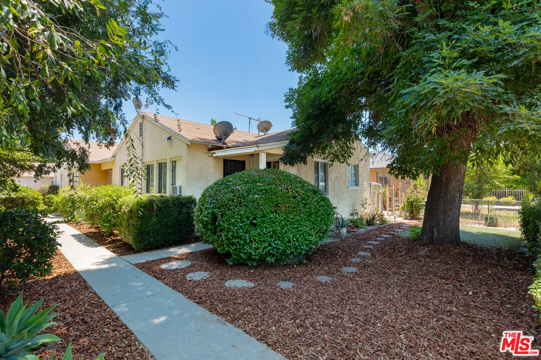 a view of a house with a tree in the background