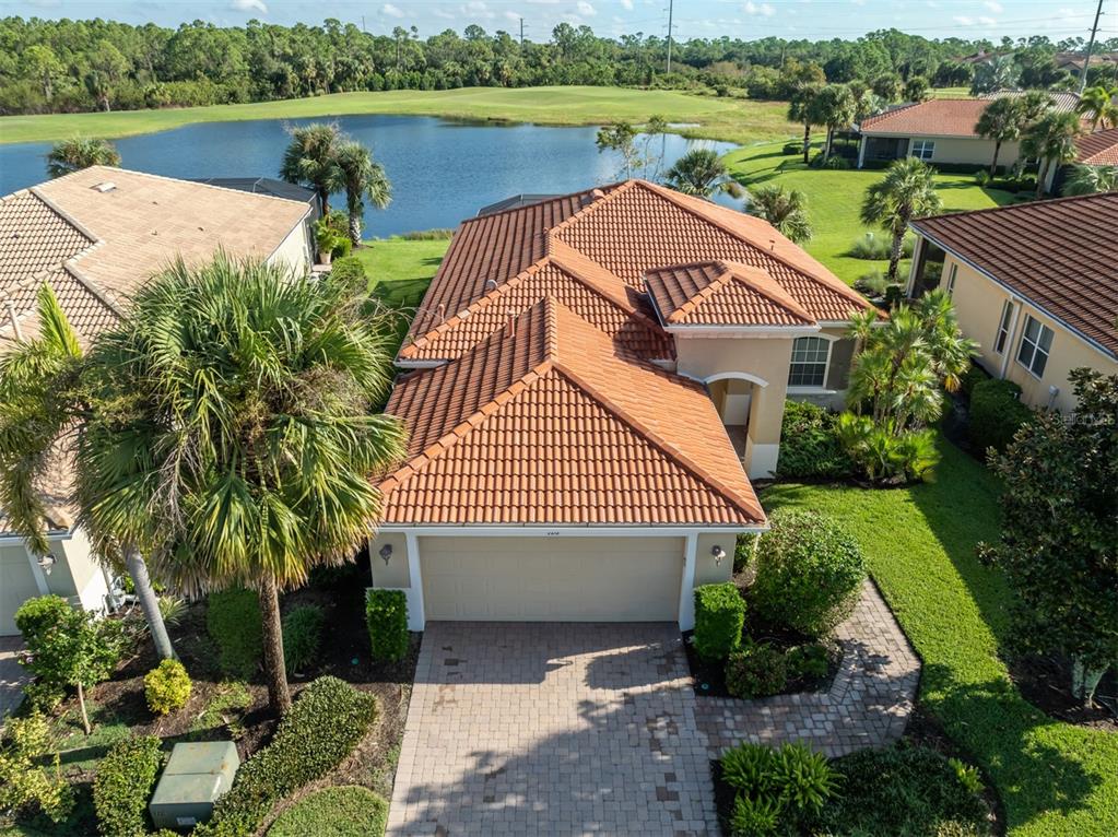 a view of a house with a yard and a pond