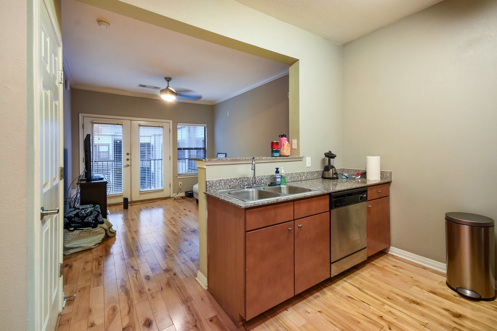 a kitchen with wooden floors and sink