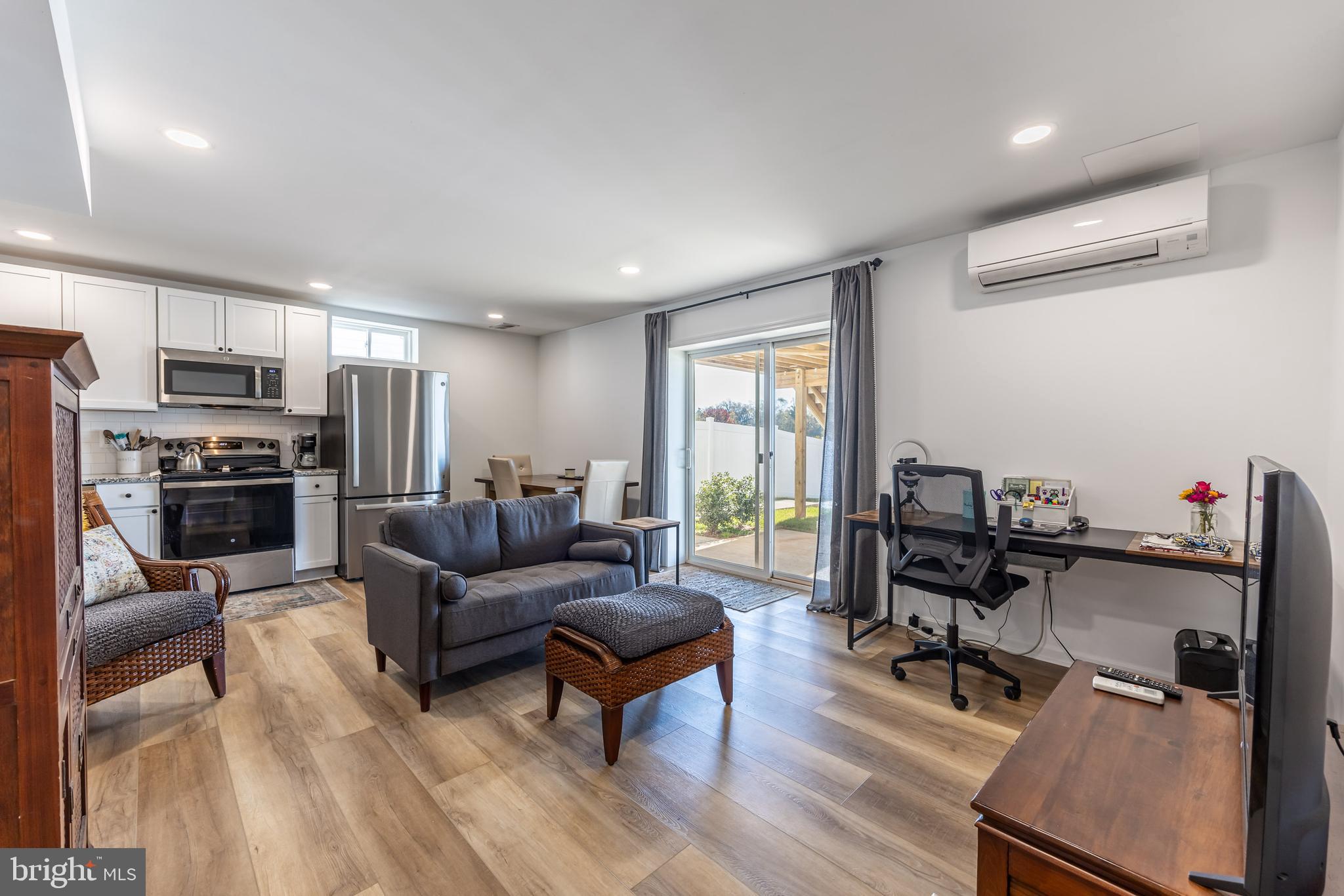 a living room with furniture a fireplace and a flat screen tv