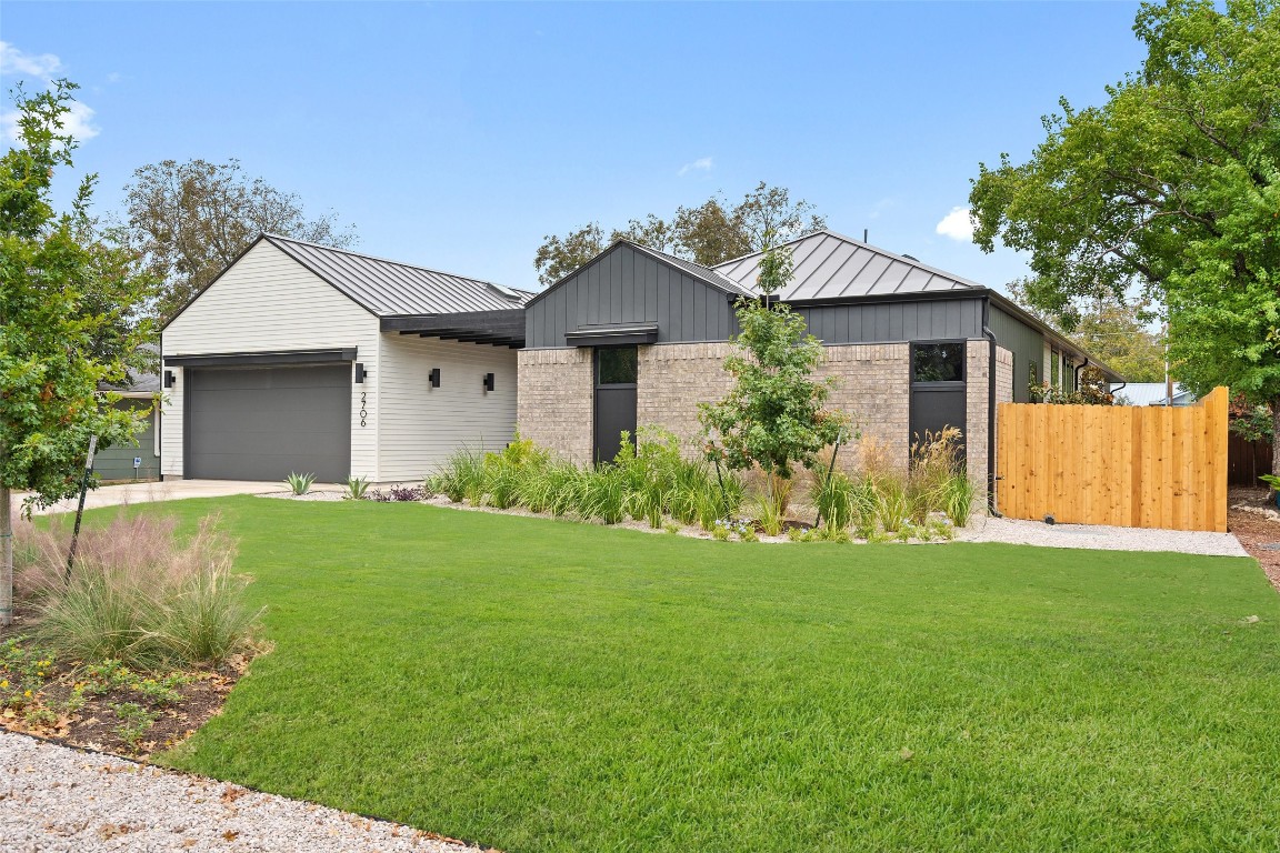 a front view of house with yard and green space