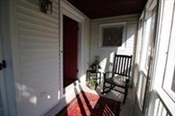 a view of an entryway door and deck of the house