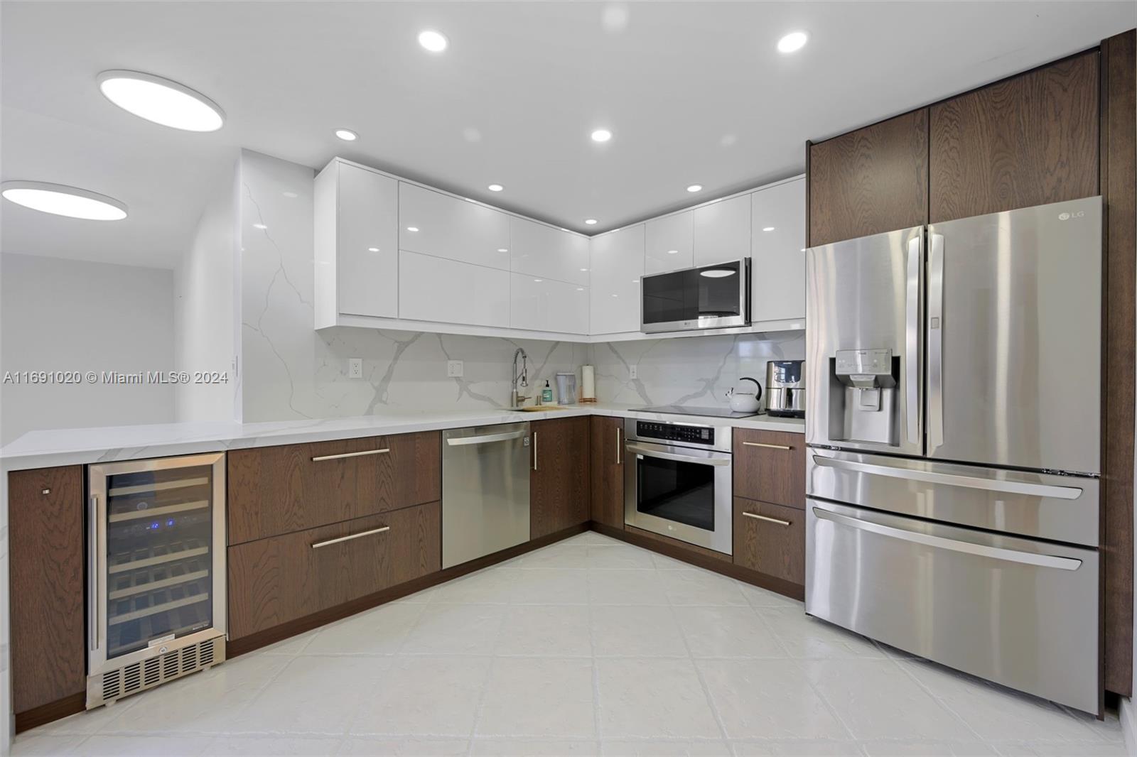 a kitchen with a refrigerator and a stove top oven