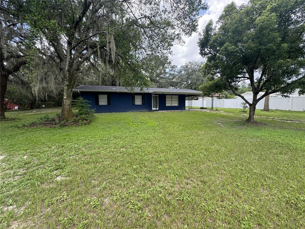 a view of a house with yard and tree s