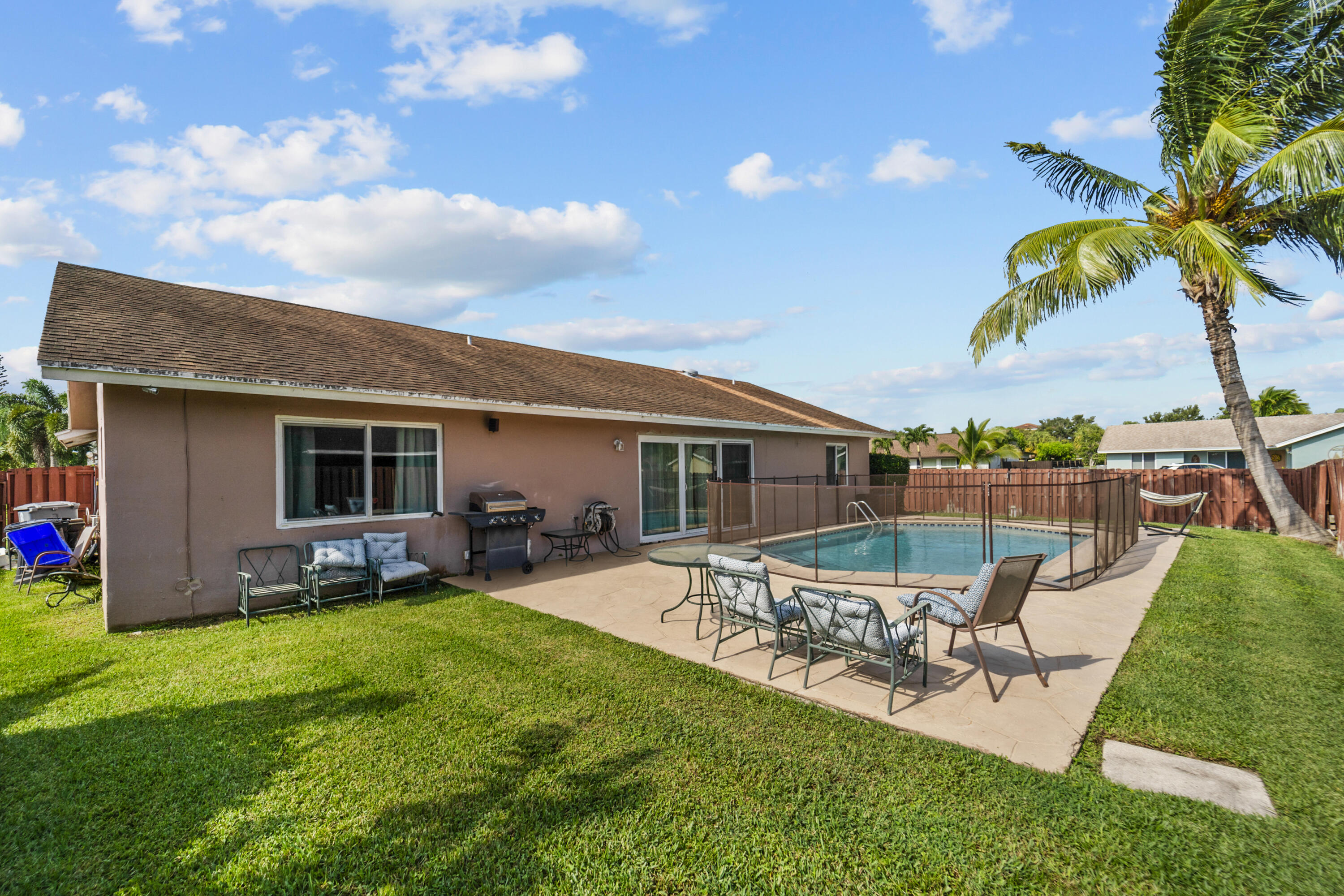 a swimming pool with outdoor seating and yard