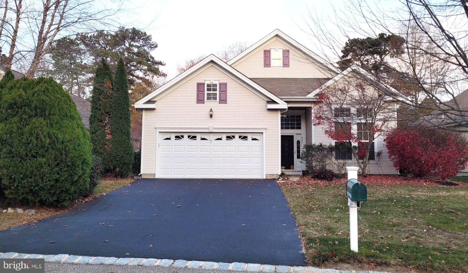 a view of a house with a yard and garage