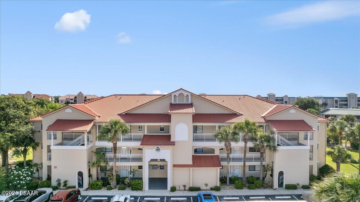 a front view of a residential apartment building with a yard