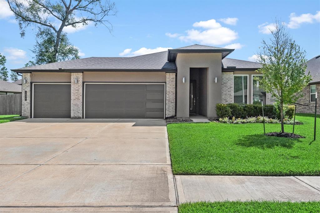 a front view of a house with a yard and garage